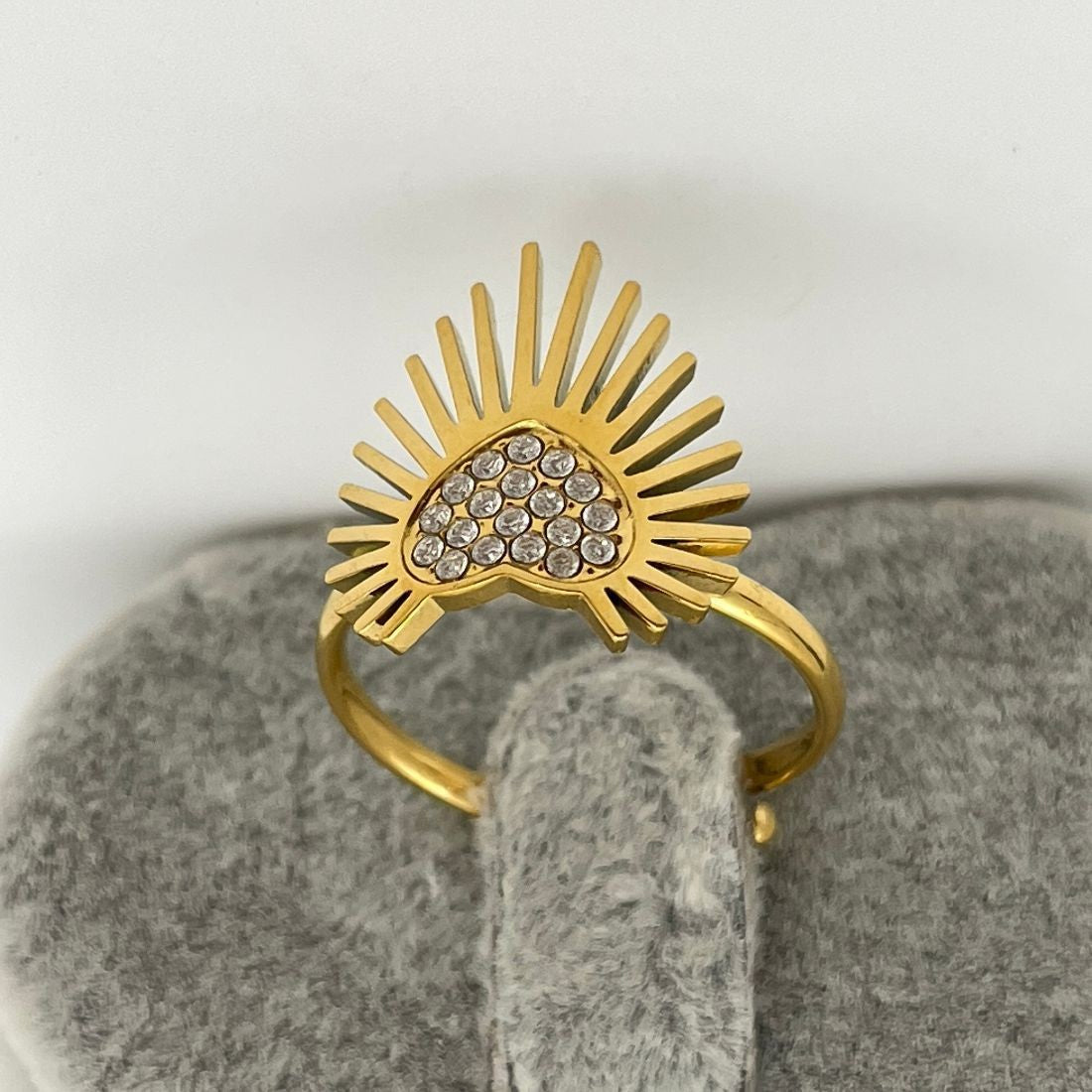 Gold ring with sunburst design and heart-shaped gemstones