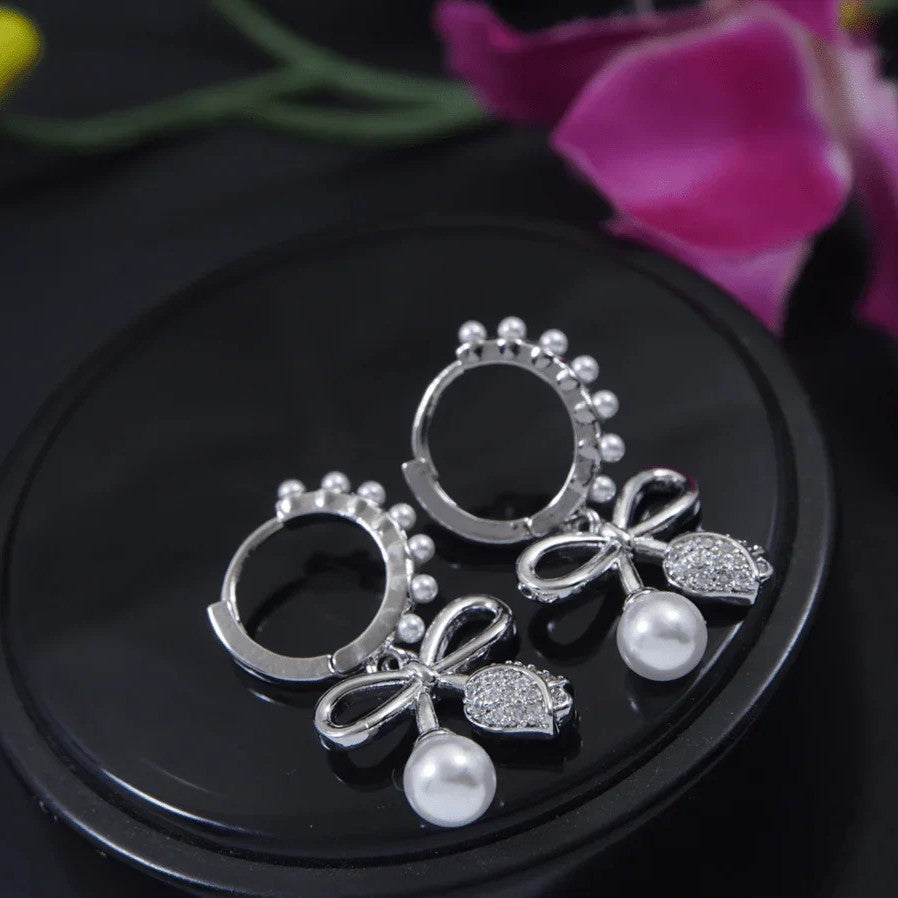 Jazbaat Silver-Plated Bowknot Design Pearl Studded Drop Earrings