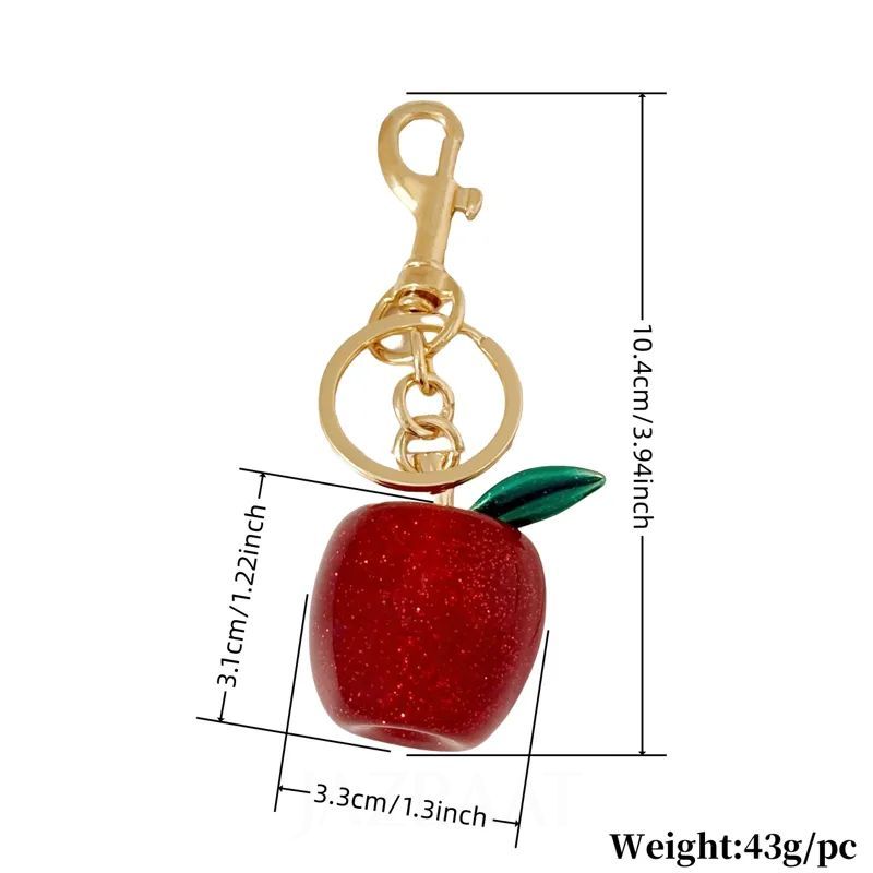 Red apple keychain with gold clasp and green leaf